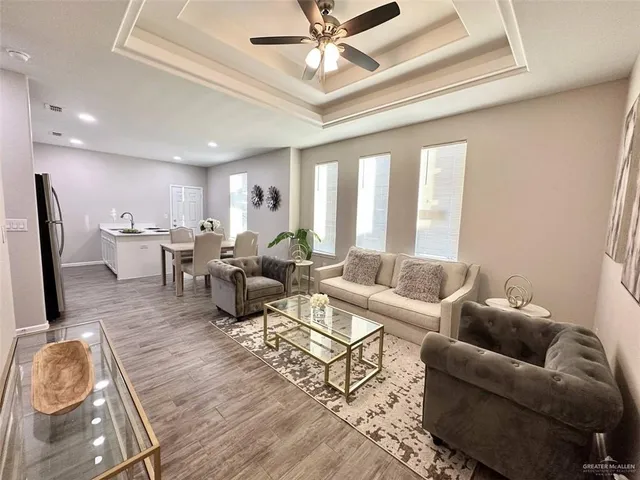a living room with lots of furniture and a chandelier