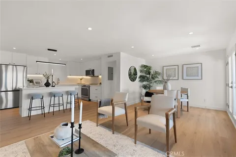 a kitchen with stainless steel appliances a sink cabinets and wooden floor