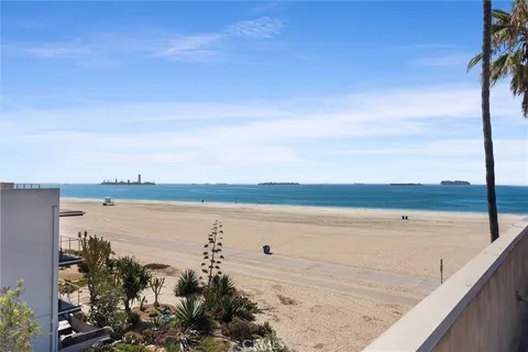 a living room with furniture a wooden floor and a large window