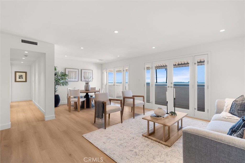 1200 East Ocean Boulevard, Unit 41 Long Beach, CA 90802 - Photo 7 of 35 a living room with furniture a wooden floor and a large window