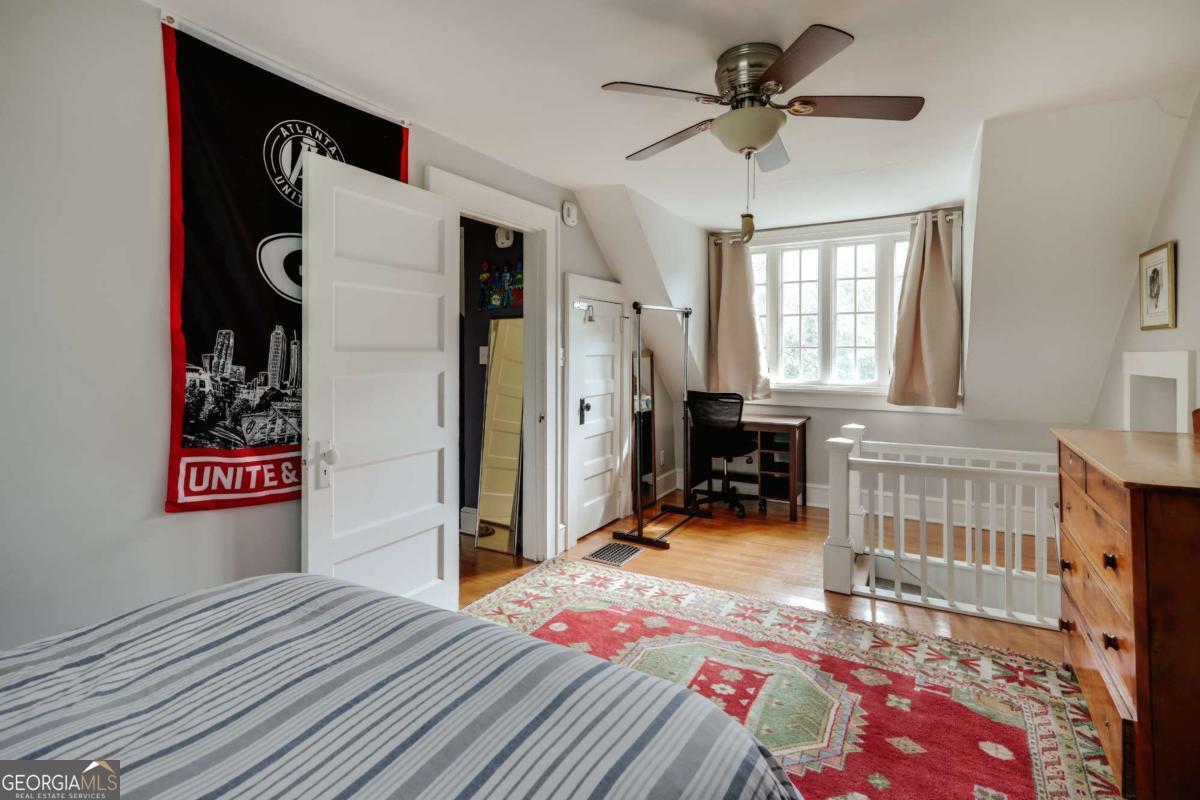 552 Cobb Street Athens, GA 30606 - Photo 32 of 55 a bedroom with furniture and a chandelier