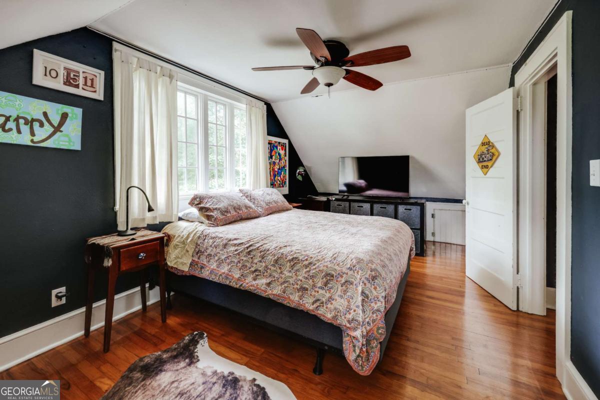 552 Cobb Street Athens, GA 30606 - Photo 35 of 55 a bedroom with a bed a window and a flat screen television