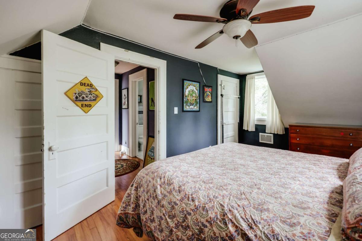 552 Cobb Street Athens, GA 30606 - Photo 36 of 55 a bedroom with a bed and a chandelier