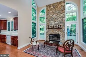 a living room with furniture a fireplace and a floor to ceiling window