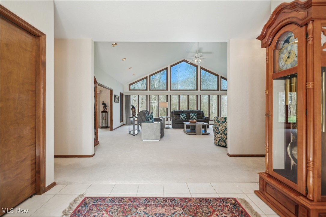 43301 Parsons Road Oberlin, OH 44074 - Photo 4 of 47 Living area featuring light tile patterned floors, a ceiling fan, and light colored carpet