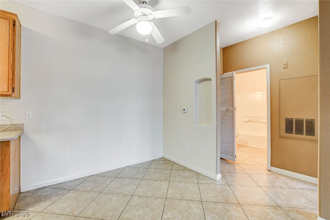 4730 East Craig Road, Unit 1005 Las Vegas, NV 89115 - Photo 10 of 45 Unfurnished dining area with light tile patterned floors and a ceiling fan