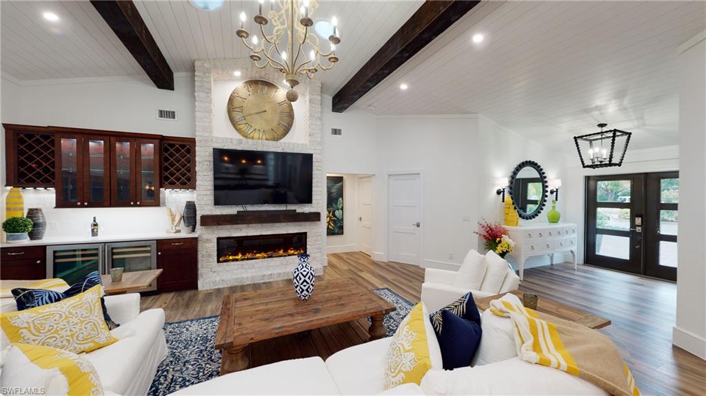 694 Regatta Court Naples, FL 34103 - Photo 1 of 33 a living room with furniture kitchen view and a wooden floor