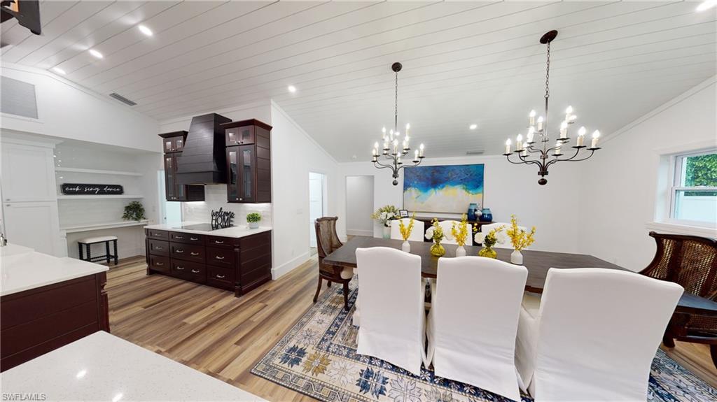 694 Regatta Court Naples, FL 34103 - Photo 13 of 33 a dining room with furniture a chandelier and window
