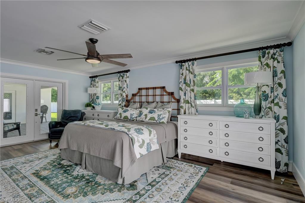 694 Regatta Court Naples, FL 34103 - Photo 16 of 33 a bedroom with a large bed and a window
