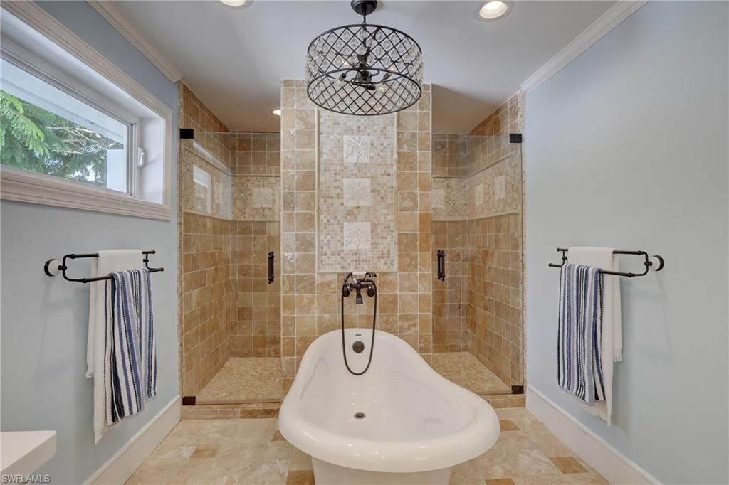 694 Regatta Court Naples, FL 34103 - Photo 18 of 33 a bathroom with a sink and a mirror