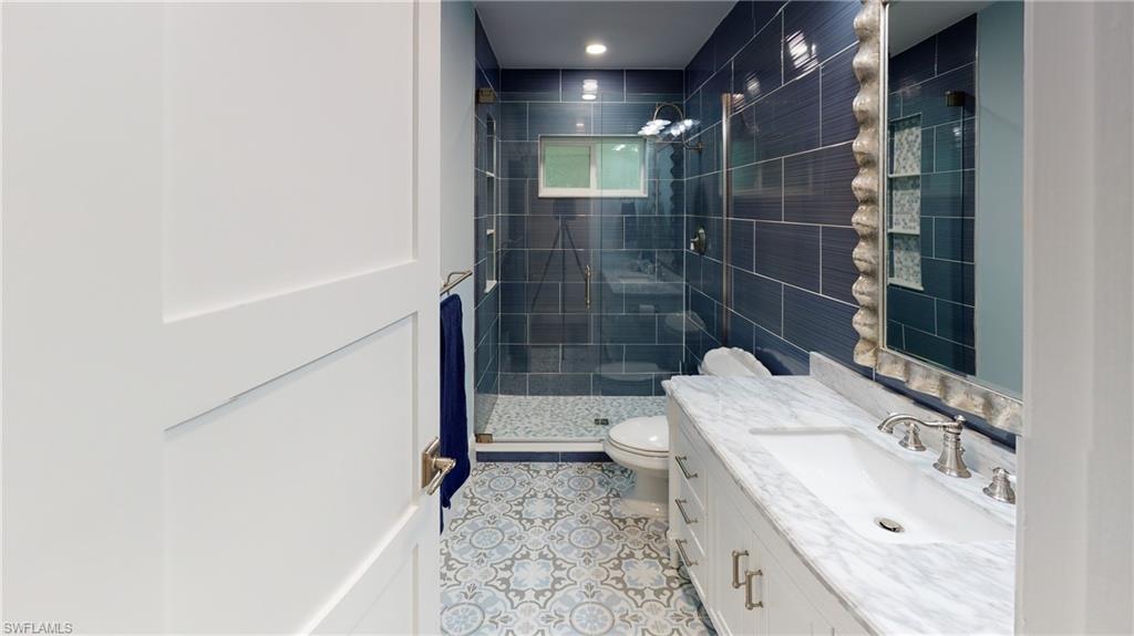 694 Regatta Court Naples, FL 34103 - Photo 21 of 33 a bathroom with a sink toilet and shower