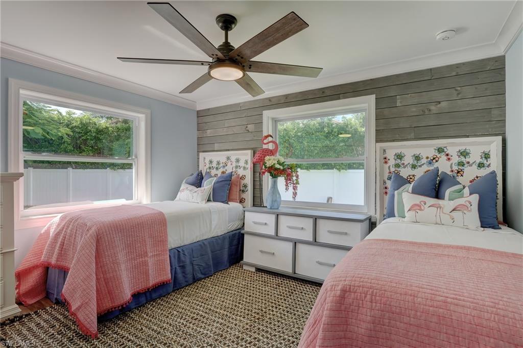 694 Regatta Court Naples, FL 34103 - Photo 22 of 33 a bedroom with a large bed and a large window