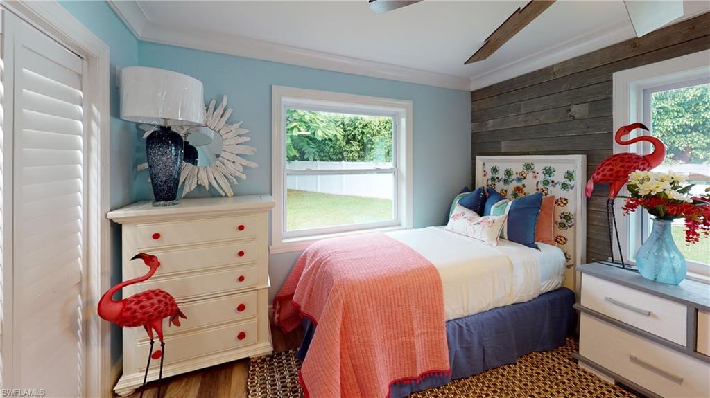 694 Regatta Court Naples, FL 34103 - Photo 23 of 33 a bedroom with a bed and a window