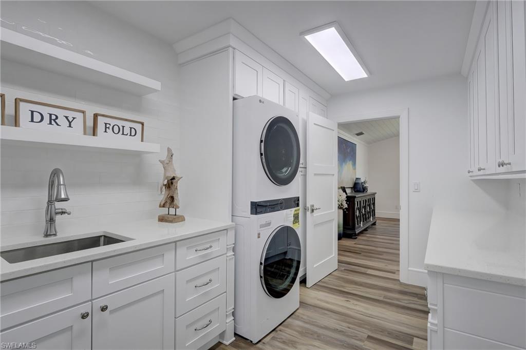 694 Regatta Court Naples, FL 34103 - Photo 26 of 33 a utility room with sink dryer and washer