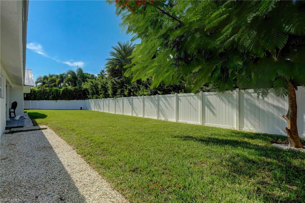 694 Regatta Court Naples, FL 34103 - Photo 29 of 33 a view of a yard with a palm tree