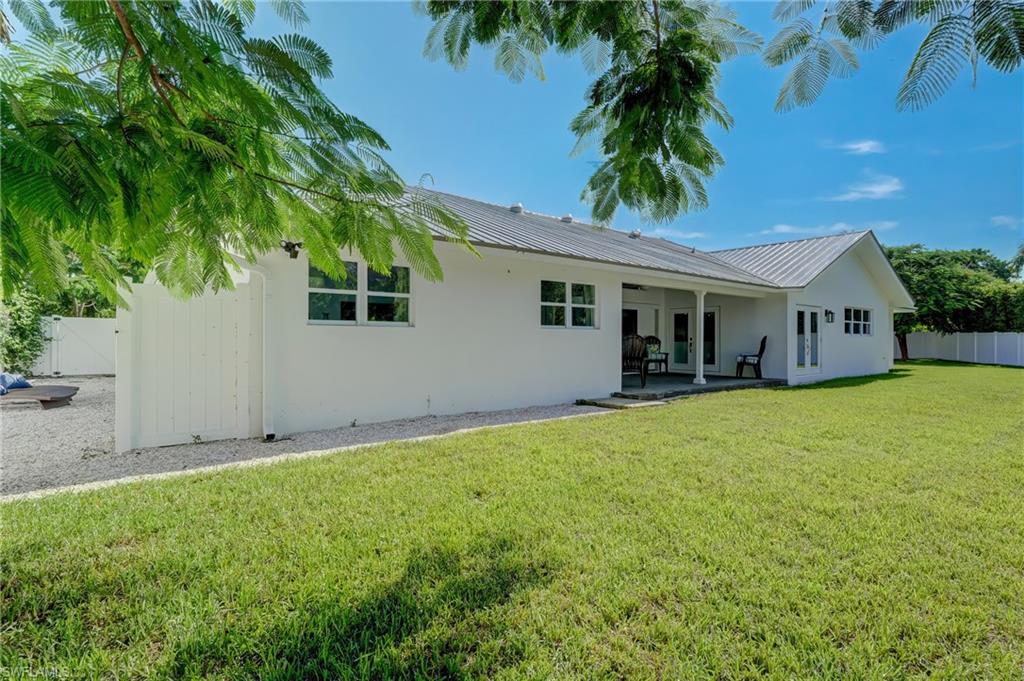 694 Regatta Court Naples, FL 34103 - Photo 30 of 33 a front view of house with yard and green space