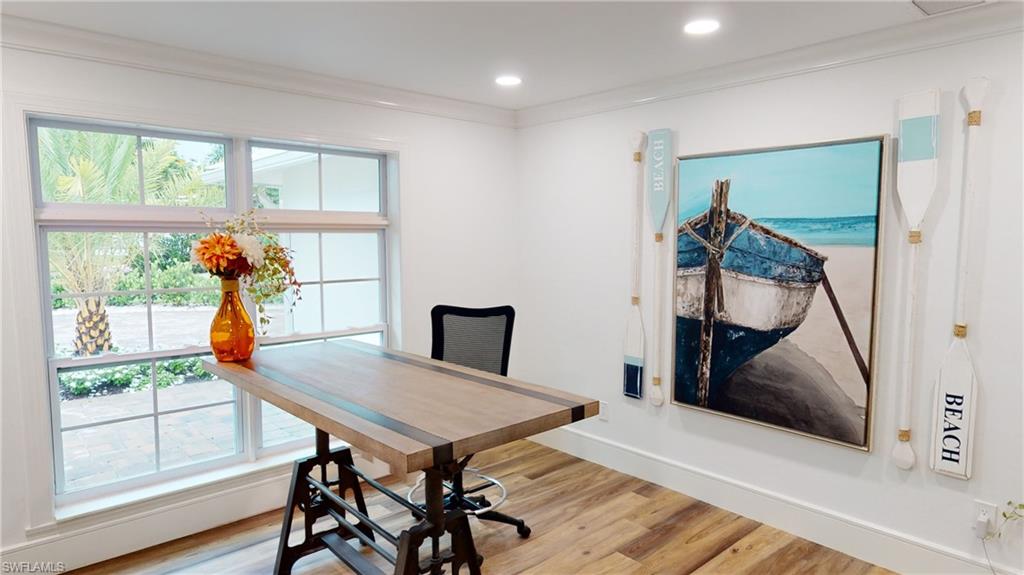 694 Regatta Court Naples, FL 34103 - Photo 3 of 33 a view of a dining room with furniture window and wooden floor