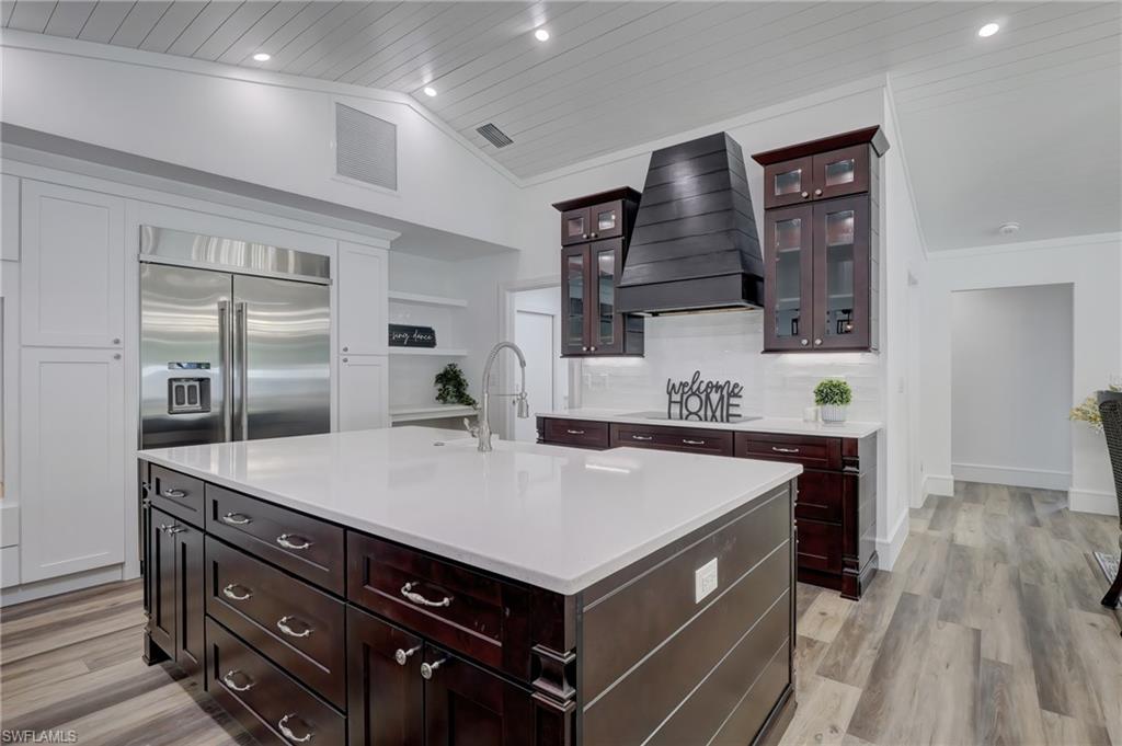 694 Regatta Court Naples, FL 34103 - Photo 10 of 33 a kitchen with a stove a refrigerator and a sink