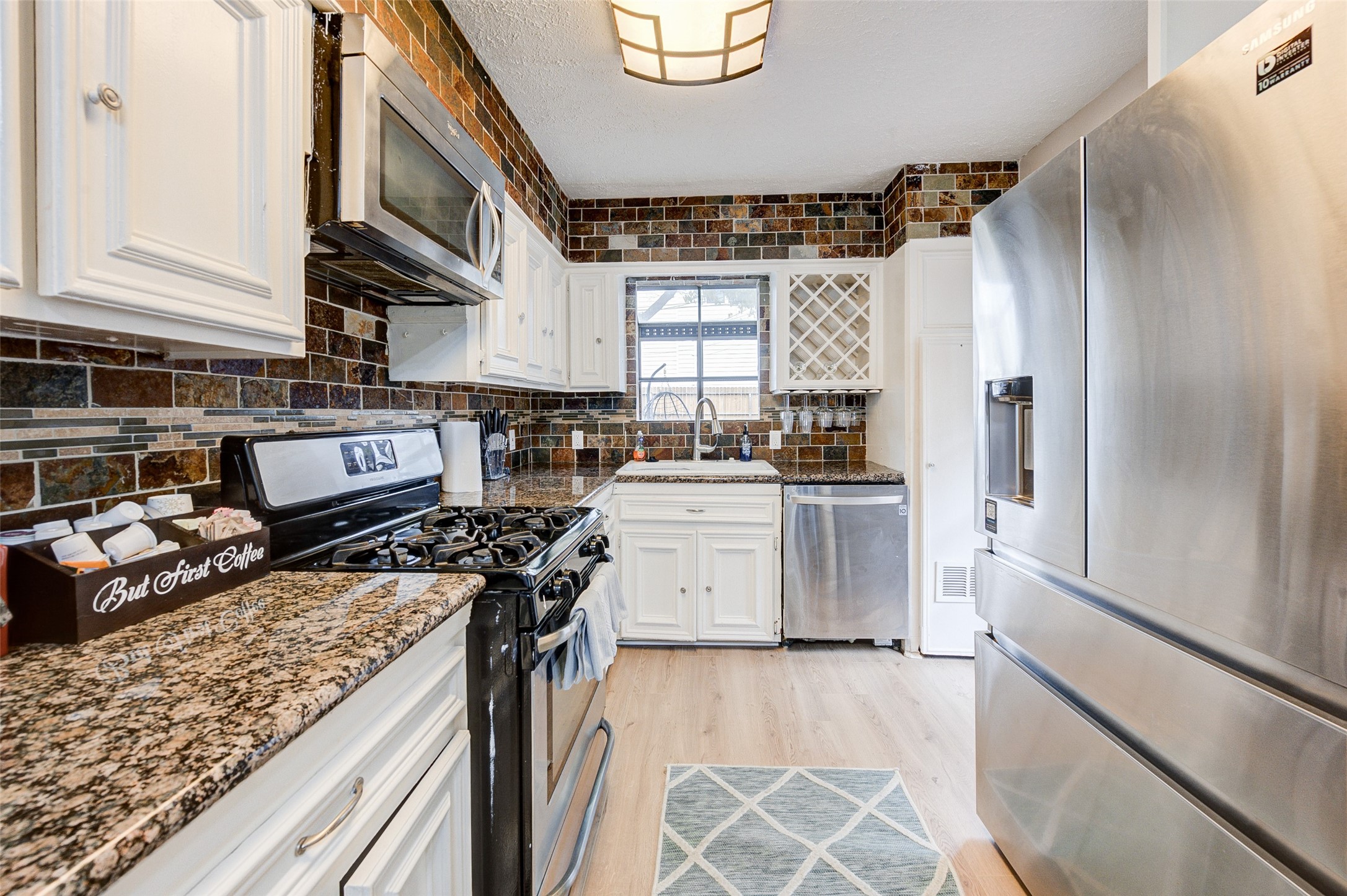1207 Archer Street Houston, TX 77009 - Photo 10 of 30 a kitchen with a stove and a refrigerator