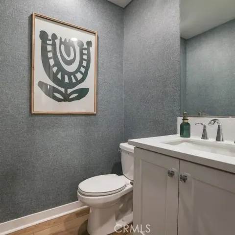 a bathroom with a toilet sink and vanity
