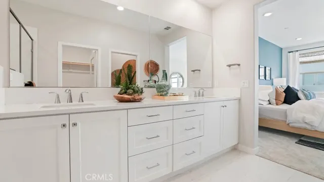 a bathroom with a double vanity sink and mirror