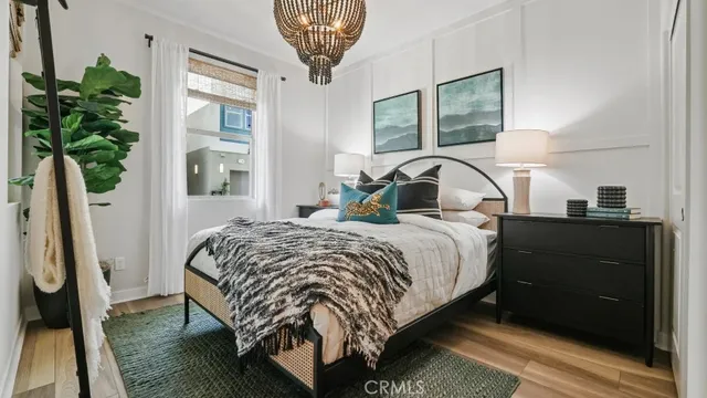 a bedroom with a large bed and a potted plant