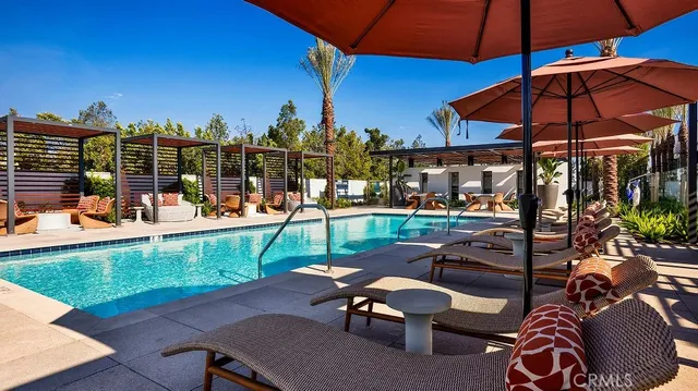 a view of a patio with a table and chairs under an umbrella