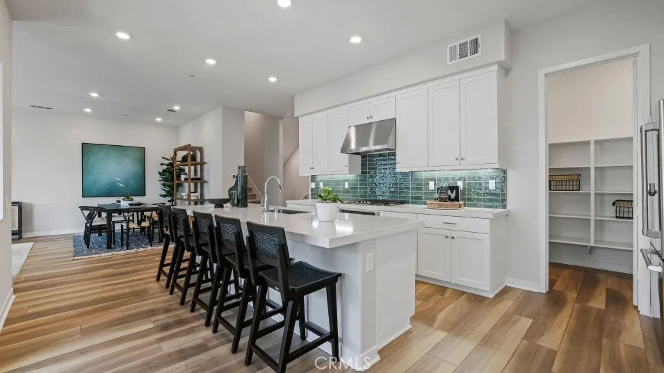 1005 Walnut Terrace Montebello, CA 90640 - Photo 4 of 37 a kitchen with stainless steel appliances kitchen island granite countertop a table chairs sink and cabinets