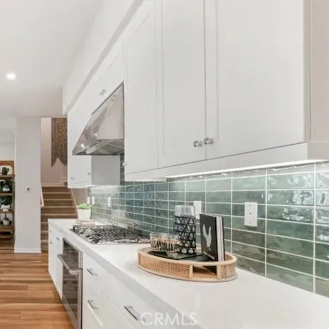 a kitchen with a sink a stove and cabinets