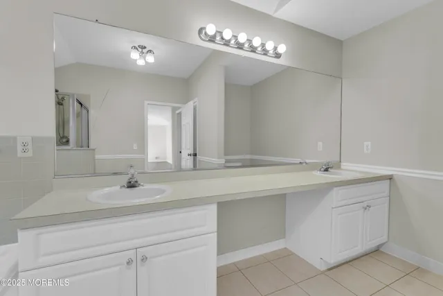 a bathroom with a double vanity sink and a mirror