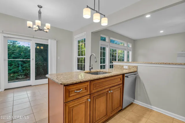 a view of a kitchen with a sink and chandelier