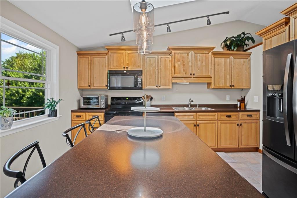 56 Regola Drive Irwin, PA 15642 - Photo 11 of 43 a kitchen with stainless steel appliances granite countertop a sink stove and refrigerator
