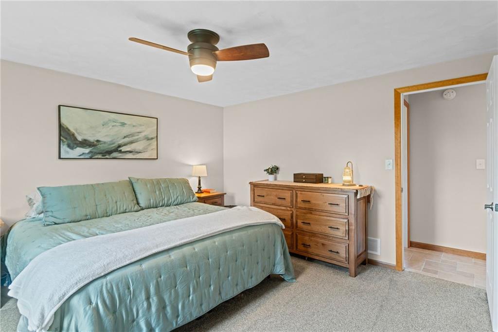 56 Regola Drive Irwin, PA 15642 - Photo 17 of 43 a bedroom with a bed and a chandelier