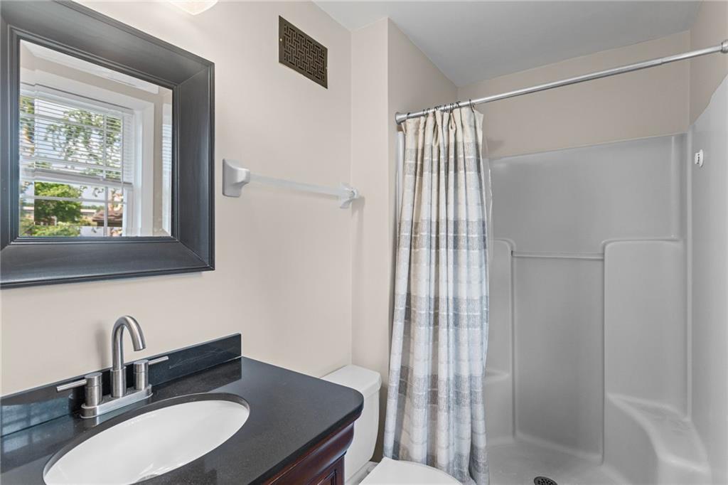 56 Regola Drive Irwin, PA 15642 - Photo 18 of 43 a bathroom with a sink toilet a mirror and shower