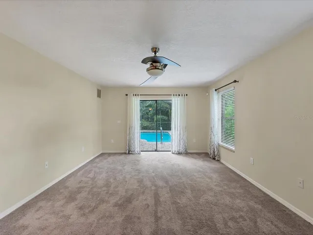 a view of a hallway with wooden floor and chandelier
