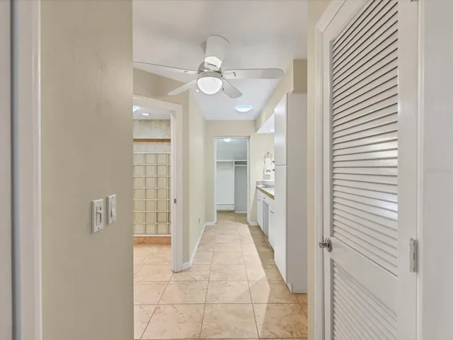 a spacious bathroom with a granite countertop sink a mirror and a shower