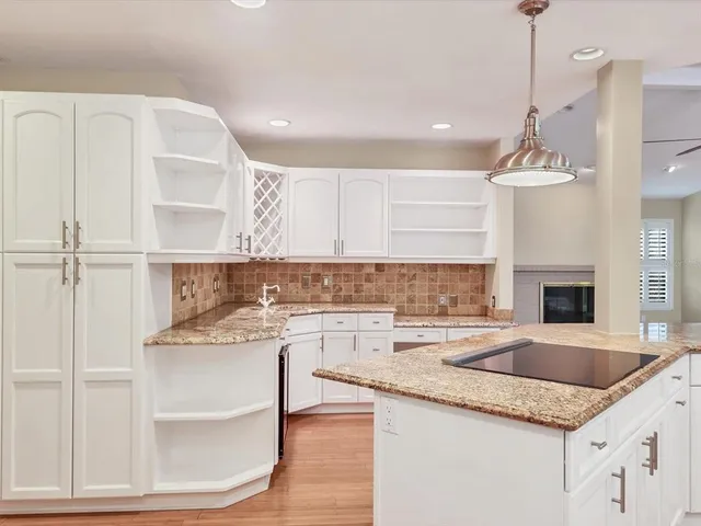 a kitchen with a sink a stove a microwave and cabinets