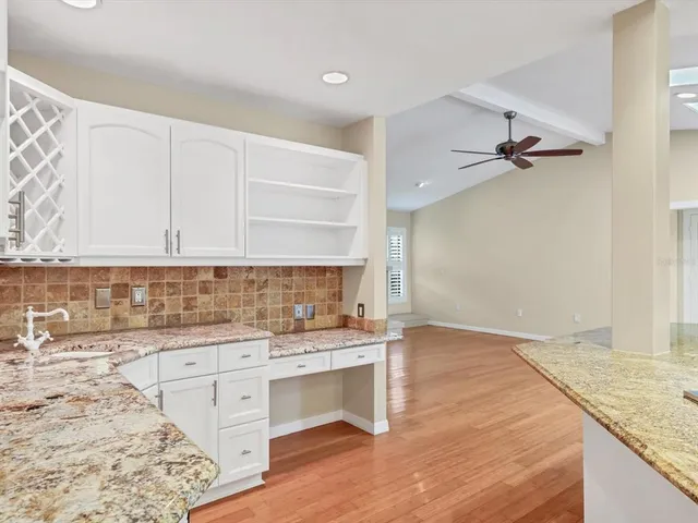 a kitchen with a sink cabinets and wooden floor