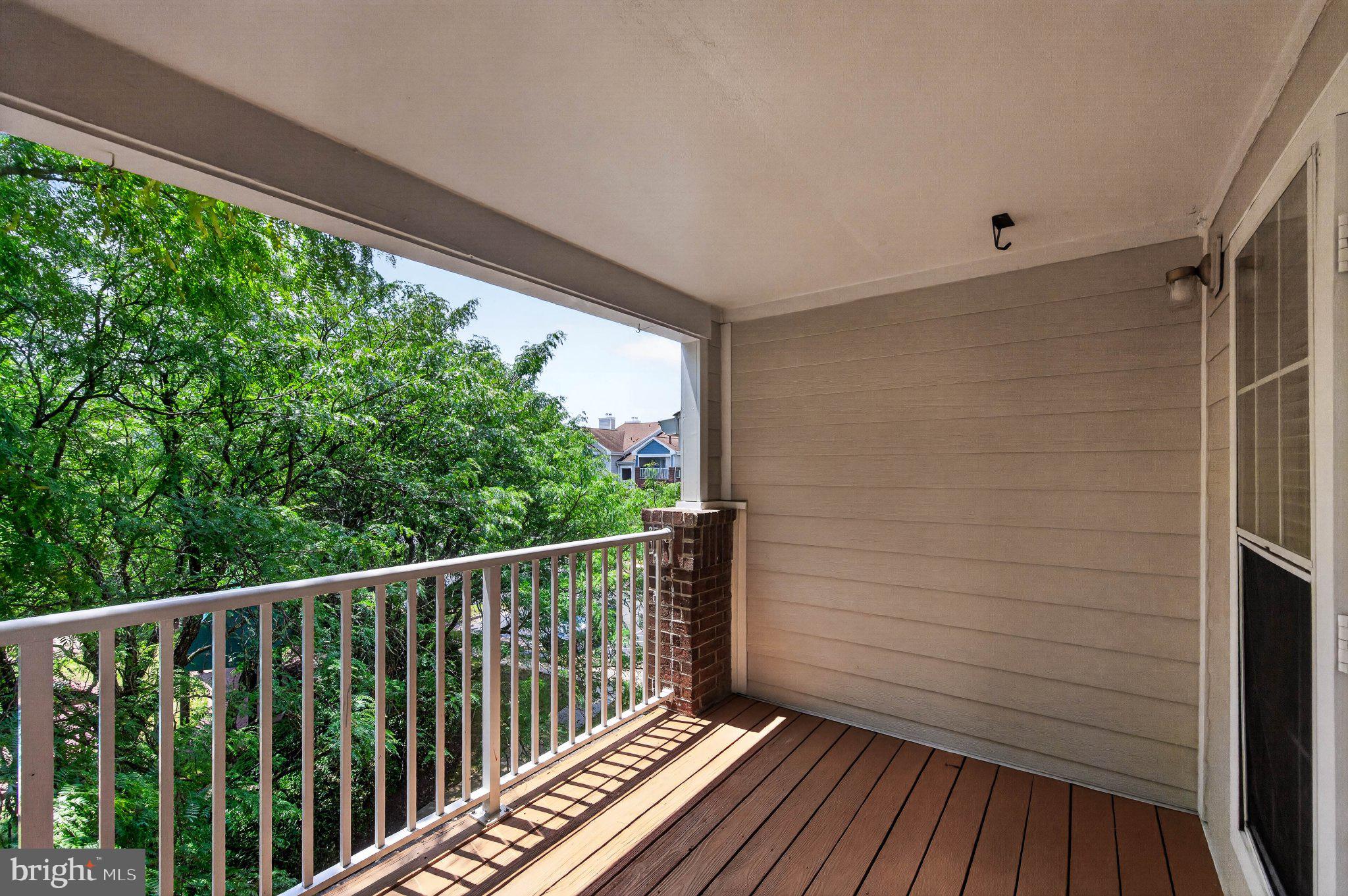 21029 Timber Ridge Terrace, Unit 302 Ashburn, VA 20147 - Photo 22 of 29 Serene balcony with lush green views.