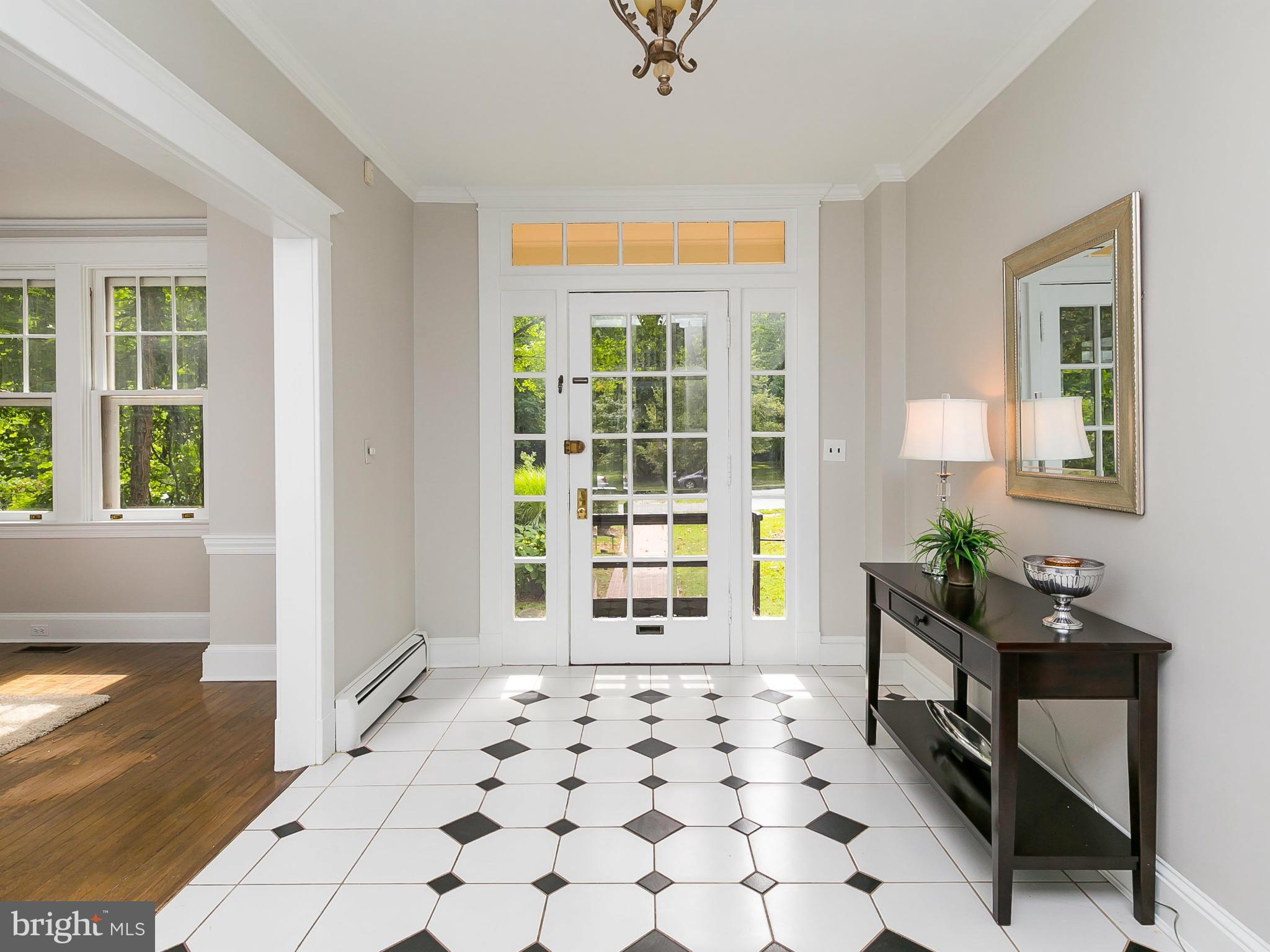2306 Ken Oak Road Baltimore, MD 21209 - Photo 2 of 30 a living room with a black white checkered floor with a large window