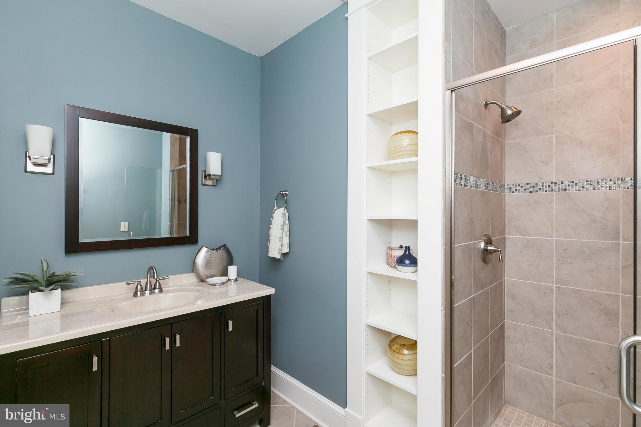 2306 Ken Oak Road Baltimore, MD 21209 - Photo 15 of 30 a bathroom with a double vanity sink mirror and shower