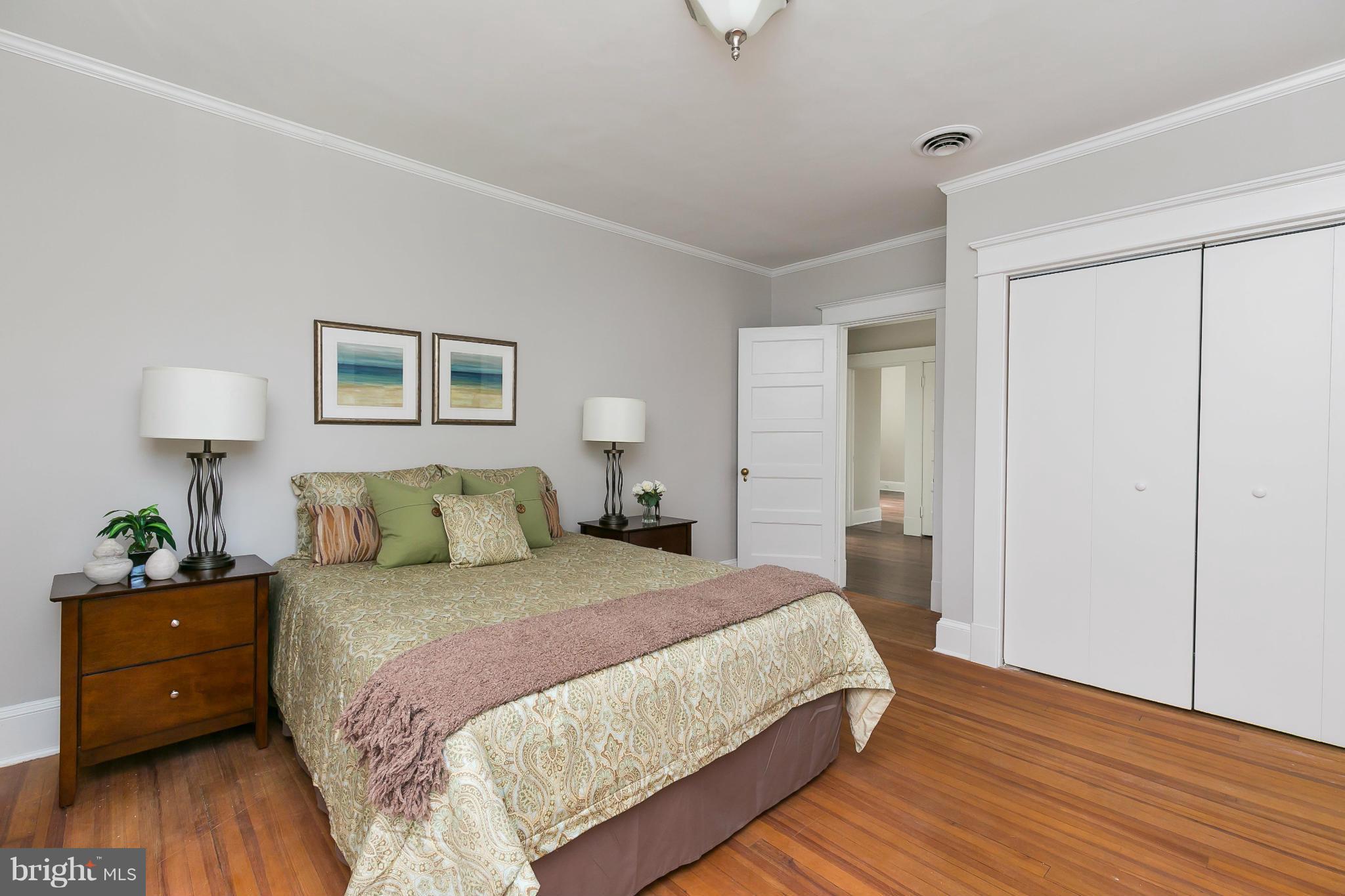 2306 Ken Oak Road Baltimore, MD 21209 - Photo 19 of 30 a bedroom with a bed and a wooden floor