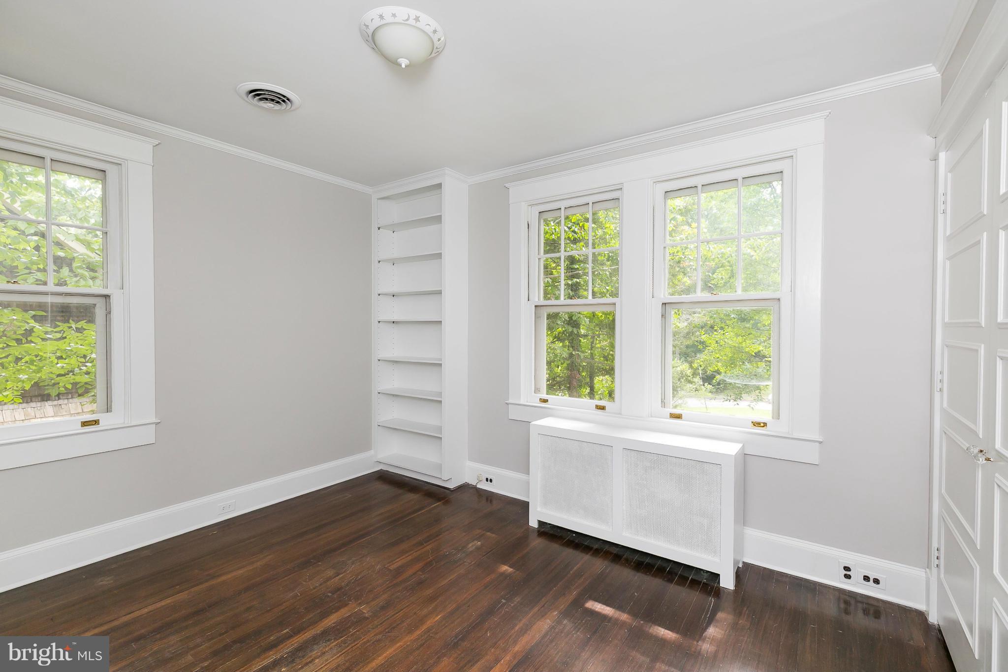 2306 Ken Oak Road Baltimore, MD 21209 - Photo 21 of 30 a view of an empty room with wooden floor and a window
