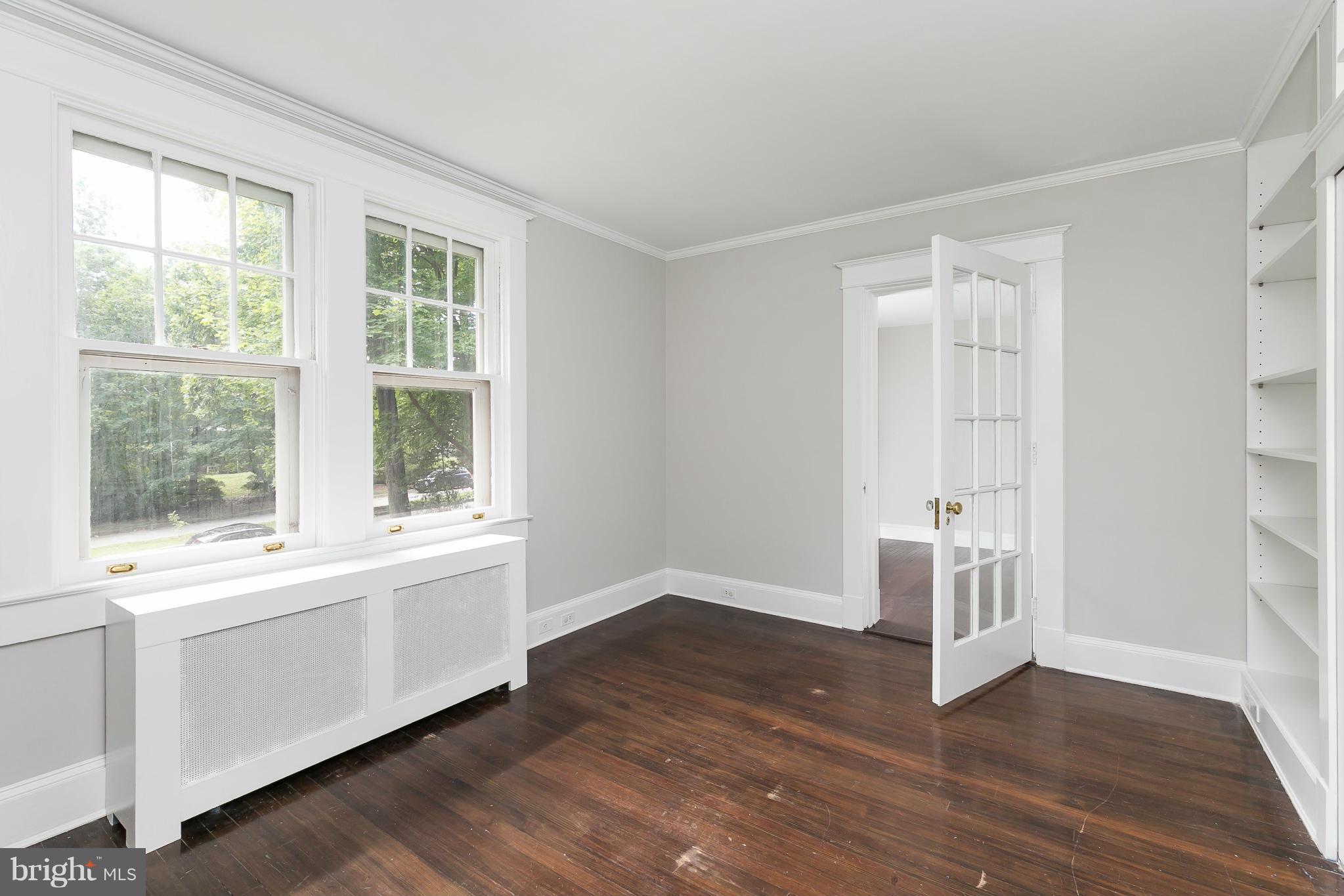 2306 Ken Oak Road Baltimore, MD 21209 - Photo 23 of 30 an empty room with wooden floor and windows