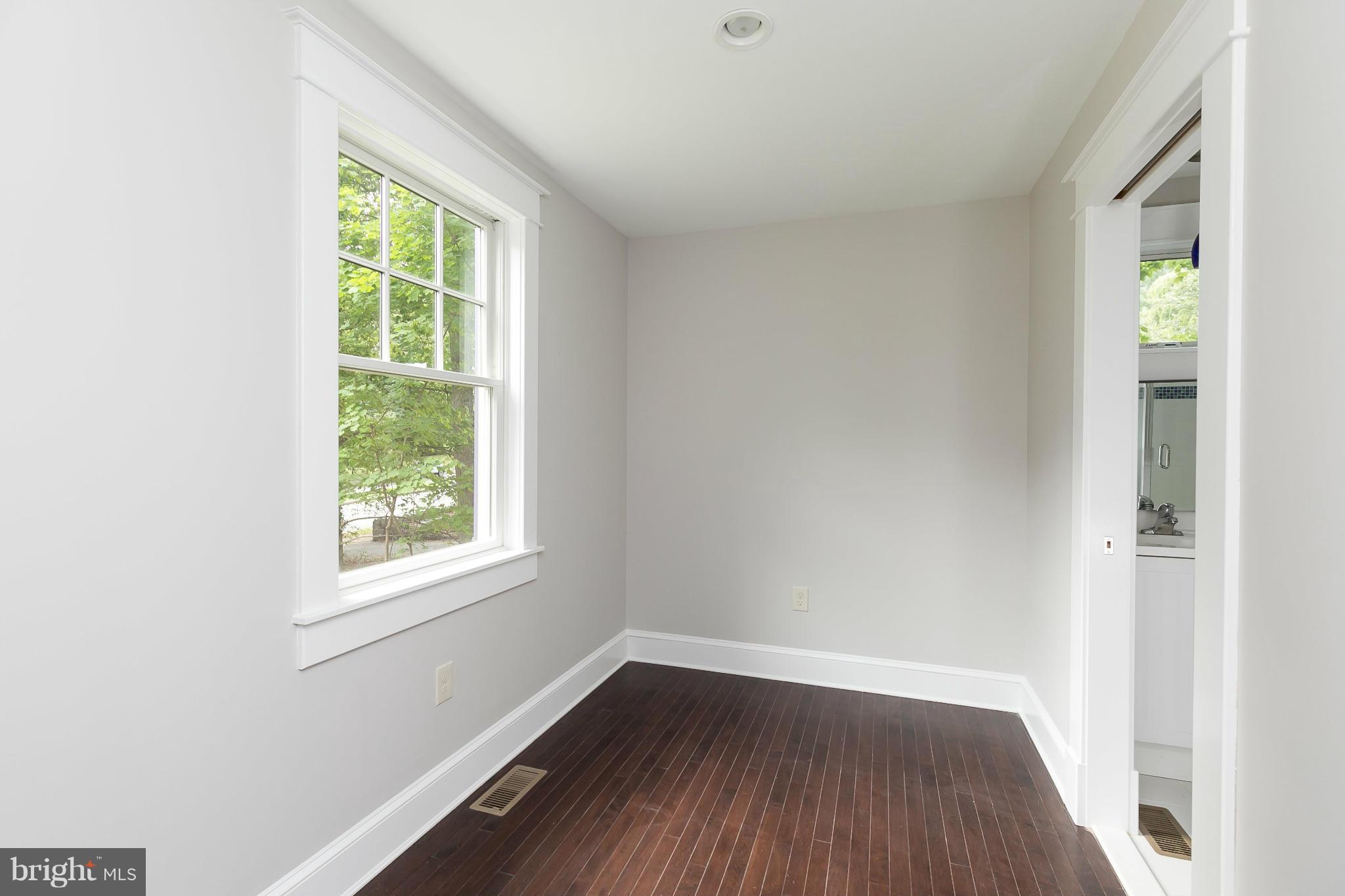 2306 Ken Oak Road Baltimore, MD 21209 - Photo 27 of 30 an empty room with wooden floor and windows