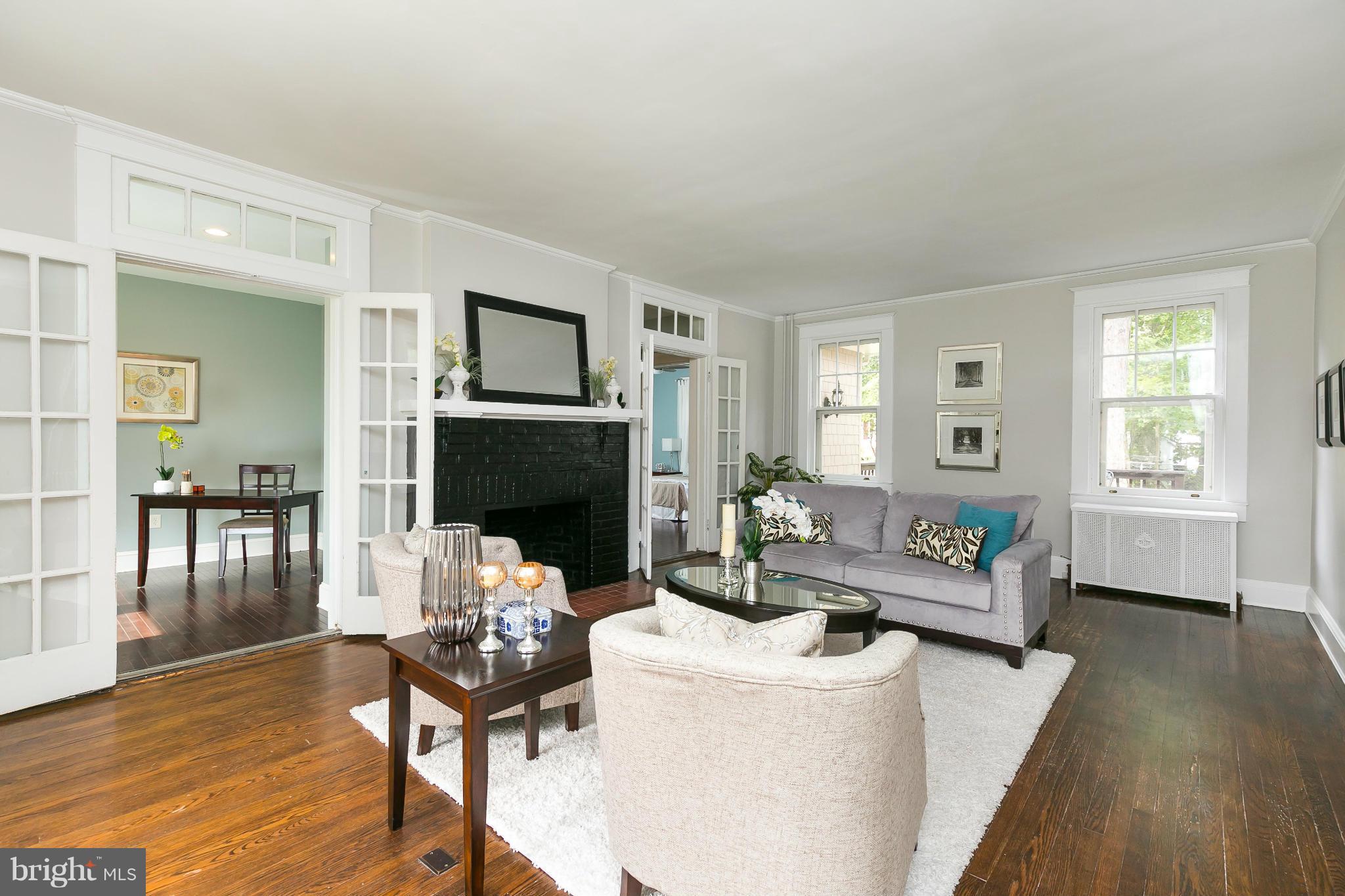 2306 Ken Oak Road Baltimore, MD 21209 - Photo 6 of 30 a living room with fireplace furniture and a wooden floor