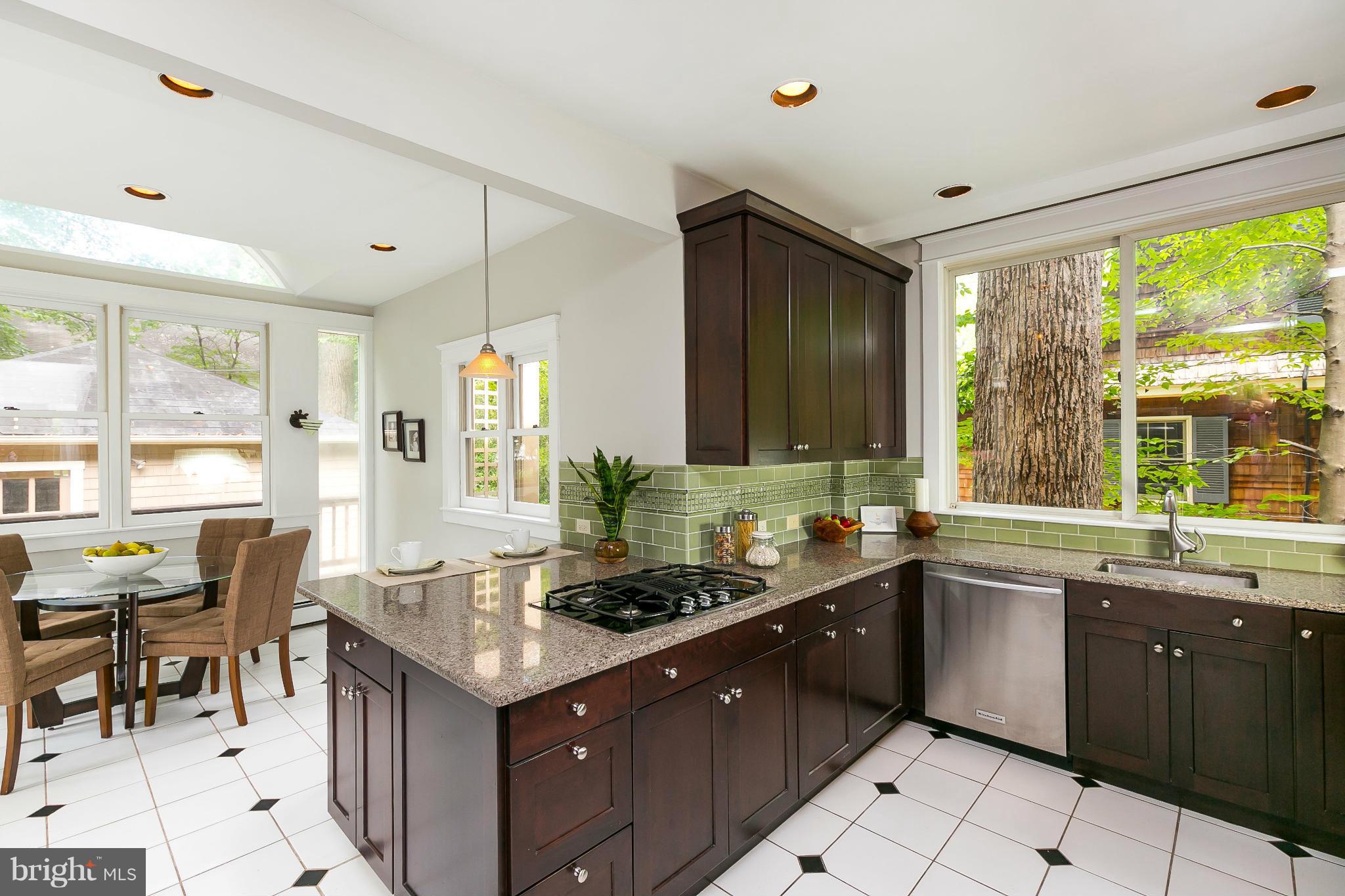 2306 Ken Oak Road Baltimore, MD 21209 - Photo 10 of 30 a kitchen with a stove a sink a refrigerator and a dining table