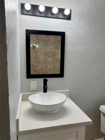 a bathroom with a sink and mirror