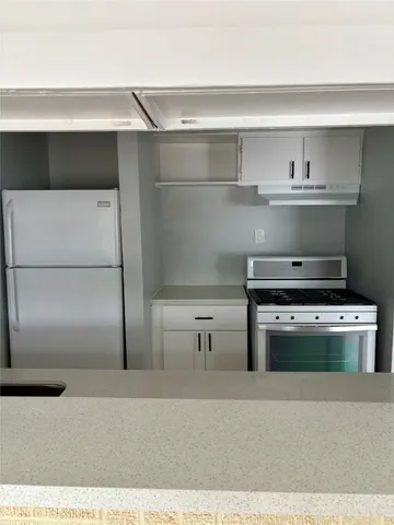 a kitchen with a stove and a refrigerator