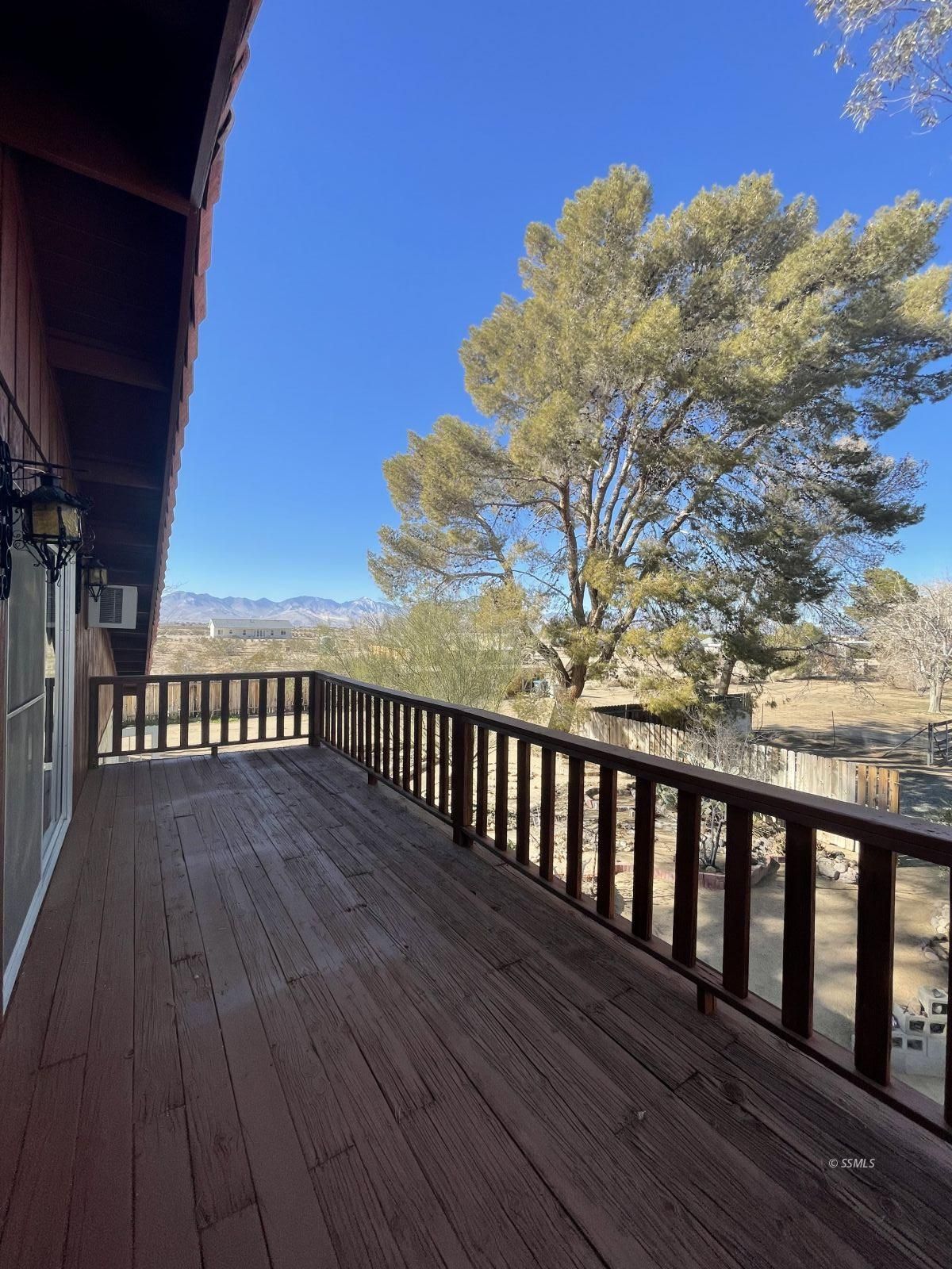 1562 West Reeves Avenue Ridgecrest, CA 93555 - Photo 25 of 45 a view of deck with wooden floor and fence
